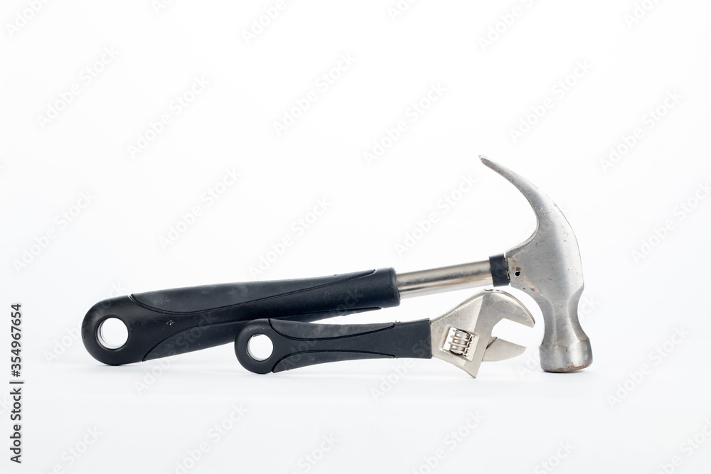 a hammer and a spanner with black rubber handle isolated on white background a hammer and a spanner with black rubber handle isolated on white background