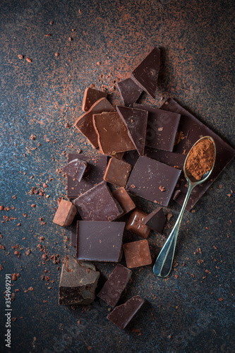 Dark and milk chocolate on a concrete background.