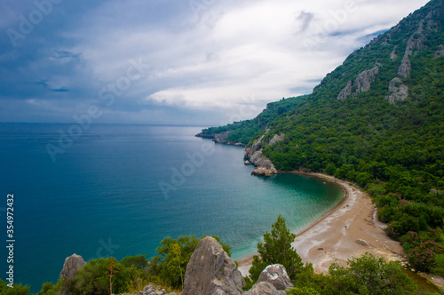Summer mediterranean coastal landscape. View of Cirali Beach from ancient Olympos ruins, with mountains and pine trees in background Antalya Turkey. © Nadezhda Kozhedub