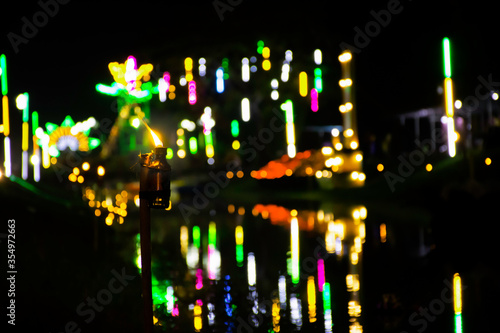 Lamp light with beautiful bokeh light background in Temple fair in Thailand © Nuttapon