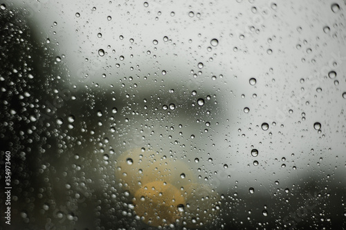 Water droplets flowing through glass