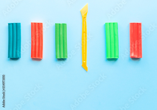 cute flower made of multi-colored plasticine clay on a pink background  multi-colored dough  minimal  children s crafts