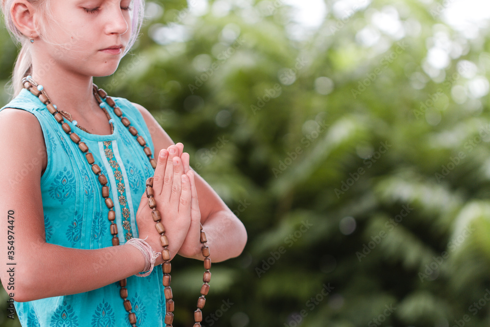 smiling caucasian girl in namaste. girl hands close up with rosary in namaste gesture outdoor summer day. yoga, mindfulness, harmony concept. Green lifestyle. Yoga day. smiling caucasian girl in namaste. girl hands close up with rosary in namaste gesture outdoor summer day. yoga, mindfulness, harmony concept. Green lifestyle. Yoga day.
