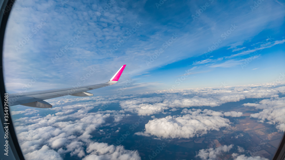 Fototapeta premium View to porthole during flight high altitude