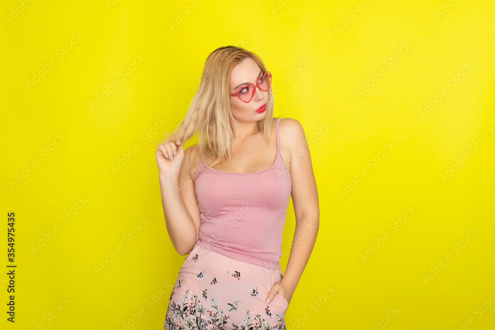 Blonde woman wearing sunglasses like hearts Blonde woman wearing sunglasses like hearts