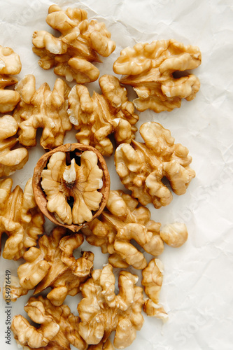Peeled walnut kernels close-up, top view. Vertical photo.