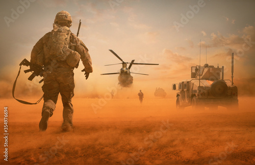 Military troops and helicopter on the way to the battlefield / Between sand storm in desert photo