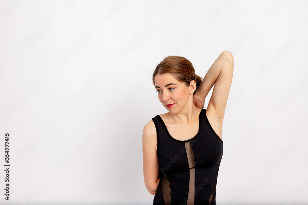 girl doing sports stretching on a white background, hands in the lock, space for text girl doing sports stretching on a white background, hands in the lock, space for text