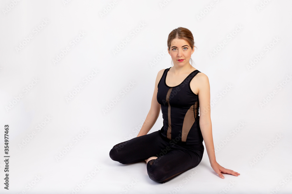 athletic girl sitting on a white background, space for text athletic girl sitting on a white background, space for text