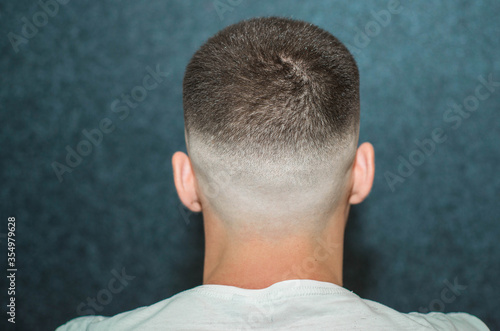 sport young man with a modern trendy fadeback haircut for barbershop