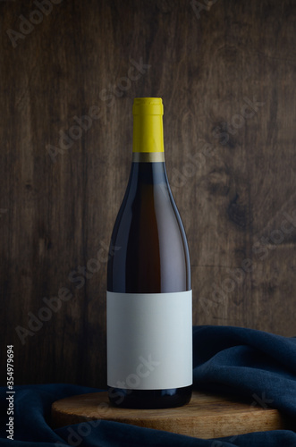 bottle of burgundy, white wine on wooden background