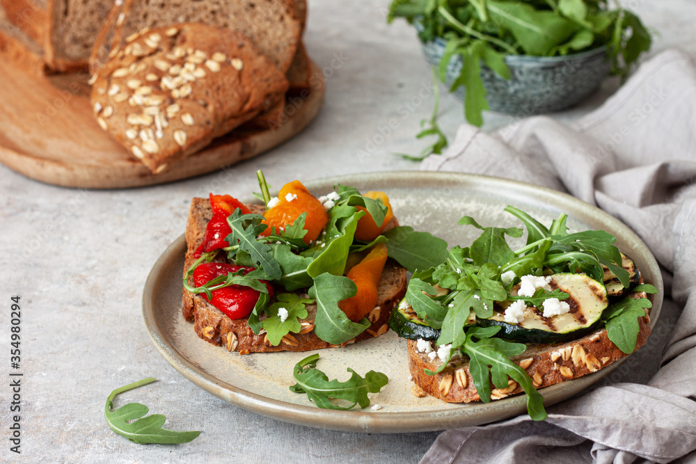 Healthy sandwich with arugula, grilled vegetables and feta