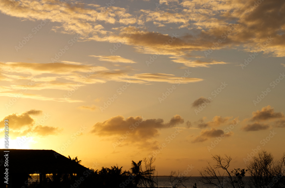 Cloudy sunset with golden and blue sky in the Caribbean