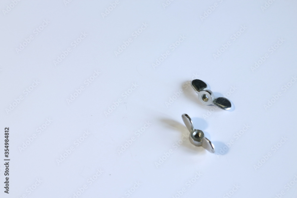 metal screws on a white table metal screws on a white table