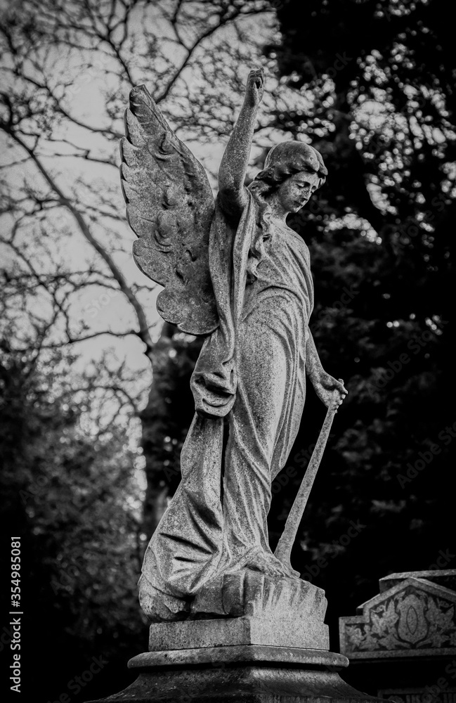 Graveyard cemetery old weathered carved stone heavenly angel statue 