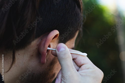 using cotton tip to clean ears