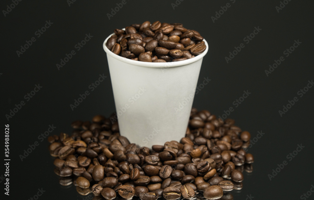 Fototapeta premium Paper cup of coffee and coffee beans on table