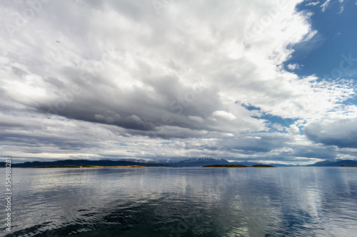 Archipelago of small islands in the Beagle Channel near Ushuaia (Argentina) with mountains in the background