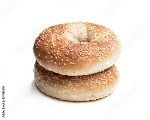 Pair of sesame seed bagels isolated on white background