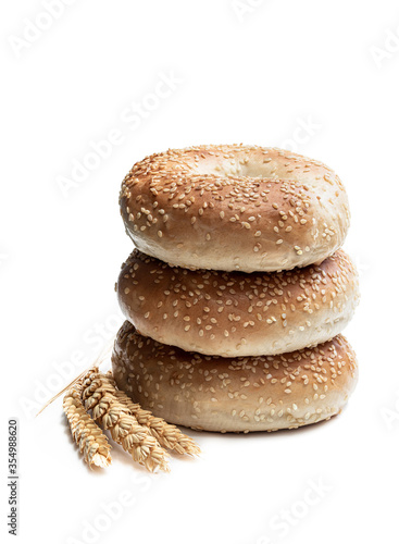 Stack of sesame seed bagels isolated on white background