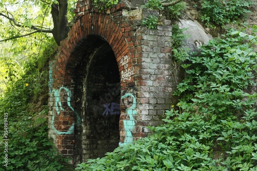 Old brick grotto in the forest view