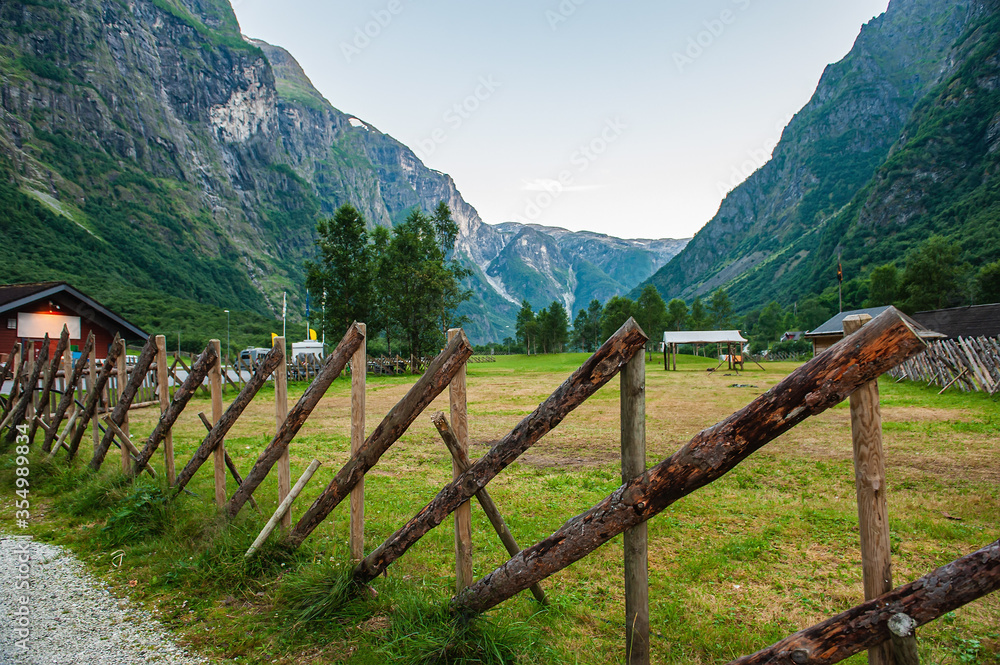 A stylized fence of the ancient Vikings. Beautiful idyllic mountain landscape. Gudvangen is a popular tourist village located at the very beginning of the Neroifjord