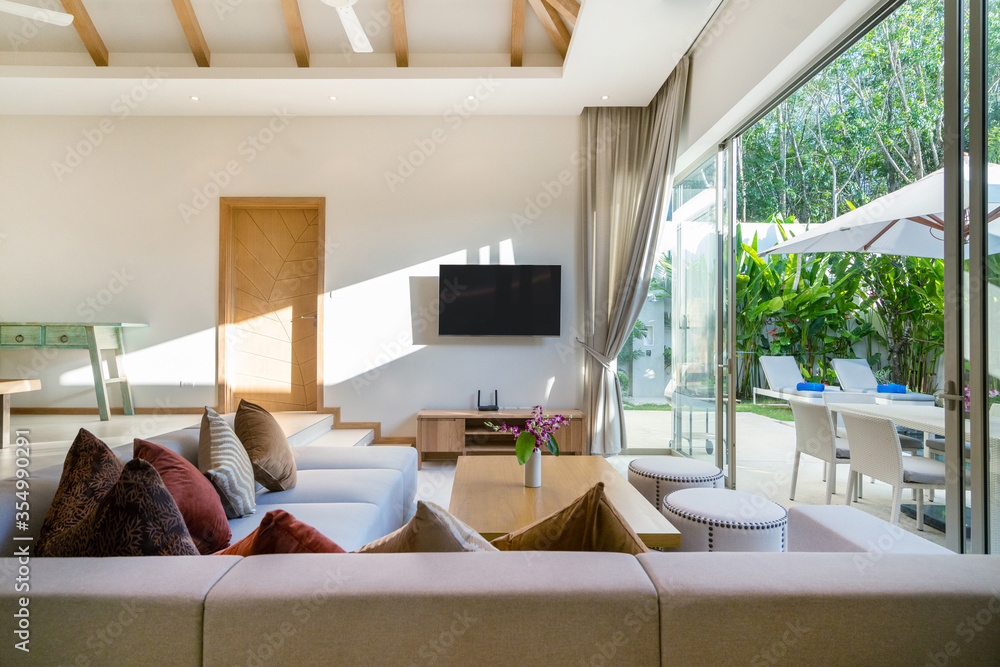 Interior and exterior design of living room with pool view in luxury ...