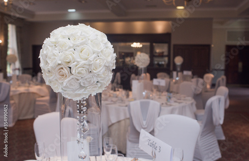 White rose table centrepieces at wedding photo