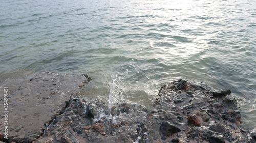 Принти на полотні Spindrift at sea with splash of water against the stone shore