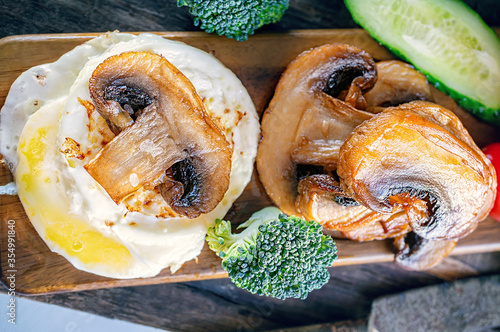 Low-calorie English Breakfast eggs Benedictine with fried mushrooms and broccoli. photo