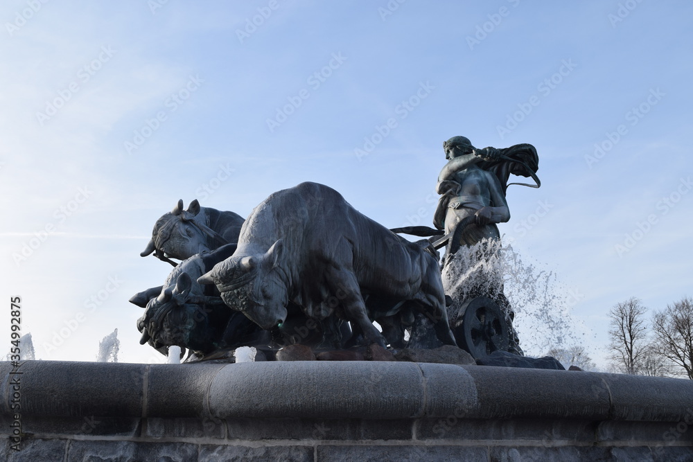 Gefion fountain with sculpture of a woman standing on a bull carriage in Copenhagen, Denmark