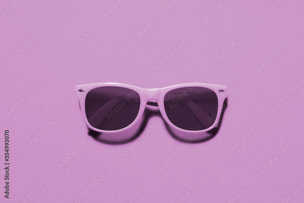 Light purple sunglasses top view  / flat lay on a matching light purple background with a centre composition