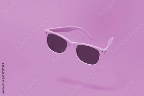Light purple sunglasses floating above a matching light purple background with a centre composition