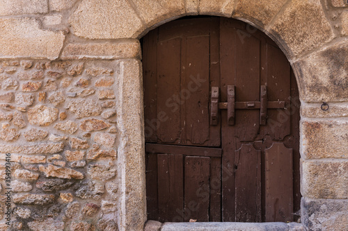 Old wooden door in stone facade photo