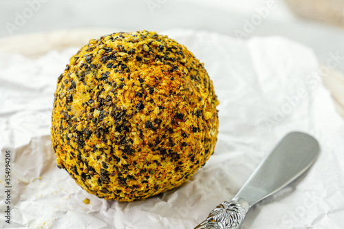 Delicacy round small cheese with black pepper and garlic. Belper Noll. A savory snack for foodies. Selective focus, copy space photo