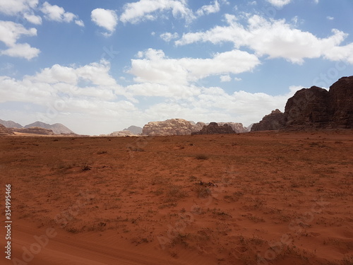 Fototapeta Naklejka Na Ścianę i Meble -  The endless expanses of the desert landscape of Wadi Rum, Jordan