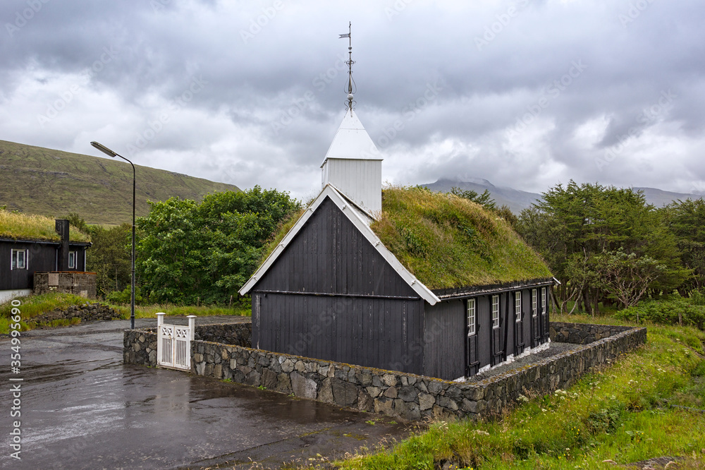 View of a small church, on the Faroe Islands. Typical is the wooden construction and the grass-covered roofs.