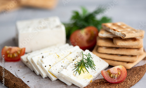 feta cheese with wheat crackers, herbs and olive oil