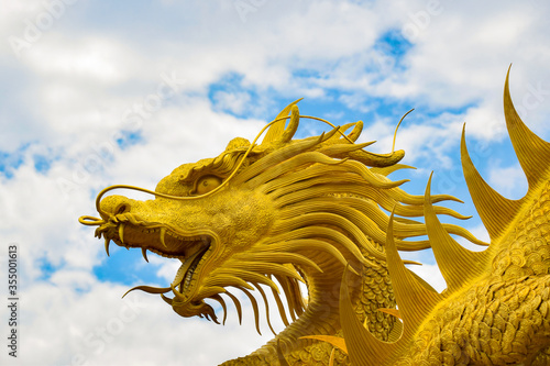 Golden dragon statue and natural blue sky background