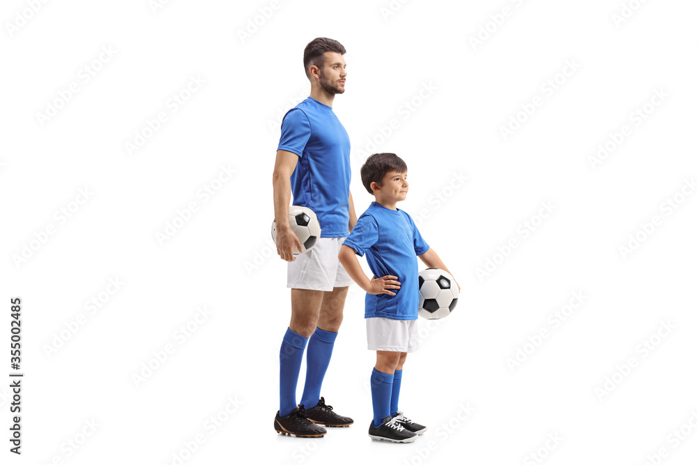 Adult and child football players in identical outfit Adult and child football players in identical outfit