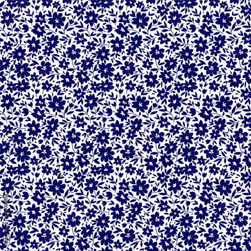 Floral pattern. Pretty flowers on white background. Printing with small navy blue flowers. Ditsy print. Seamless vector texture. Spring bouquet.