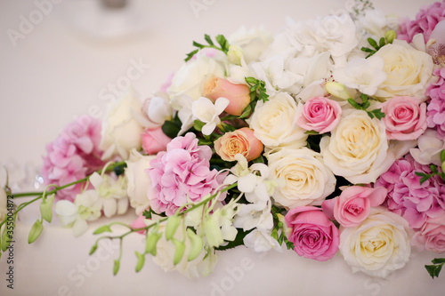 beautiful wedding arrangement with roses and other flowers