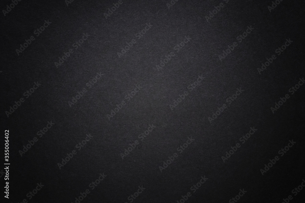 Black dark background with light copyspace in middle. Toned grunge retro vintage wallpaper with cardboard texture surface. Mockup design for dark arts. Blackout Tuesday concept. Black lives matter. Black dark background with light copyspace in middle. Toned grunge retro vintage wallpaper with cardboard texture surface. Mockup design for dark arts. Blackout Tuesday concept. Black lives matter.