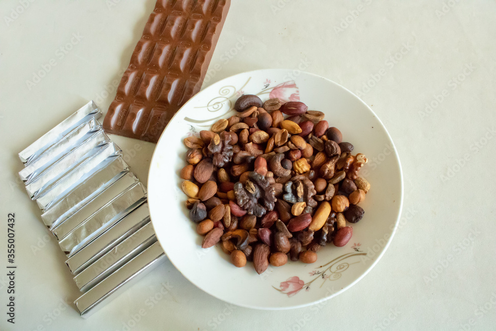 Plate with assorted nuts on a white background. Plate with assorted nuts on a white background.