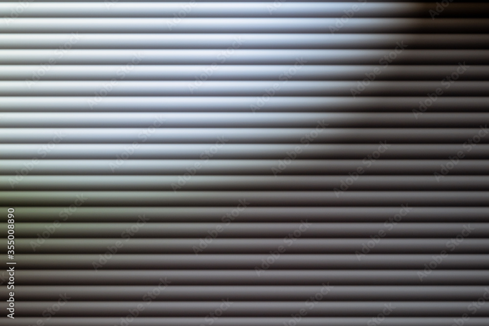 blinds in dim light. Texture or background. Abstraction. Blinds on the window. Gray depressed background blinds in dim light. Texture or background. Abstraction. Blinds on the window. Gray depressed background