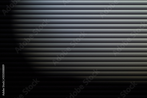 blinds in dim light. Texture or background. Abstraction. Blinds on the window. Gray depressed background