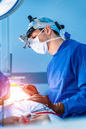 Surgeon at work in operating room. Modern equipment in operating room. Medical devices for neurosurgery.