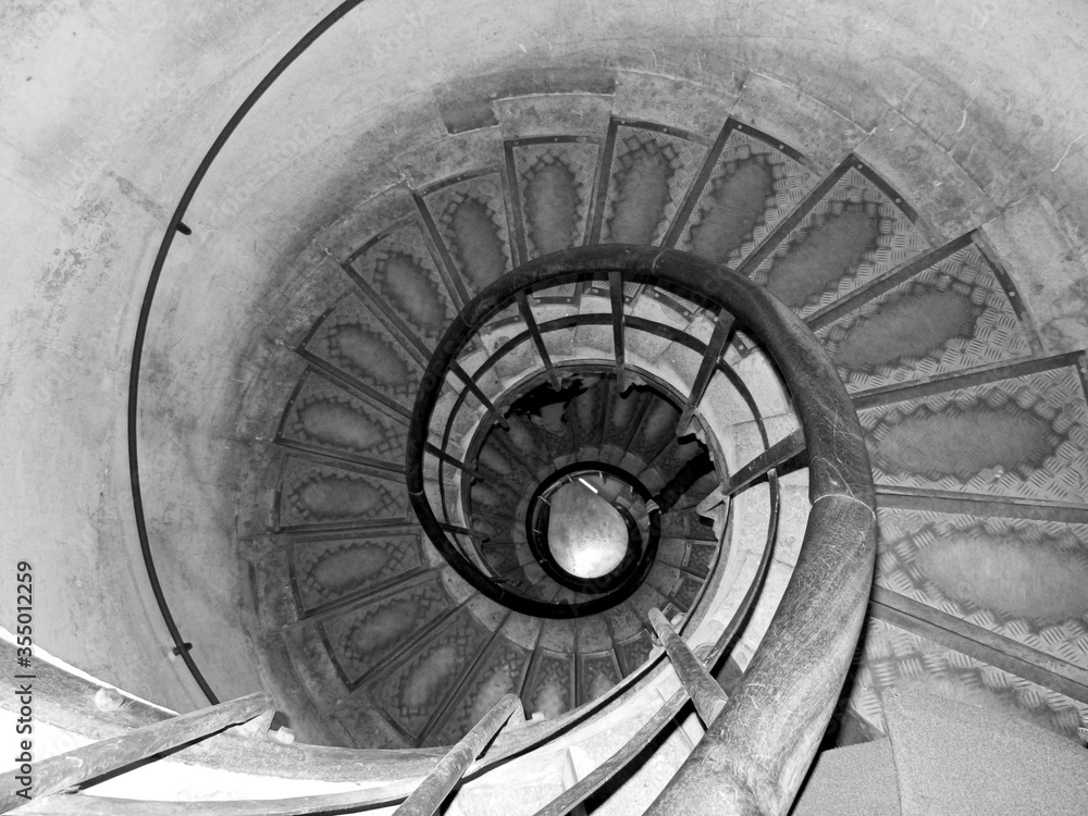 Fototapeta premium black and white photo of a spiral staircase going down