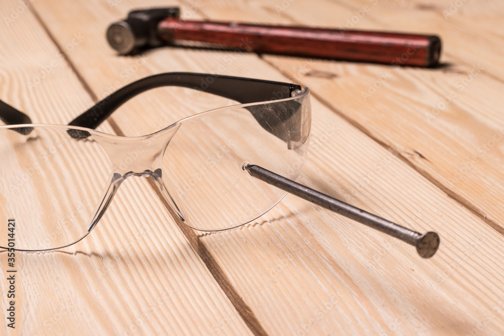 Nail stuck in safety glasses. Personal protective equipment and safety