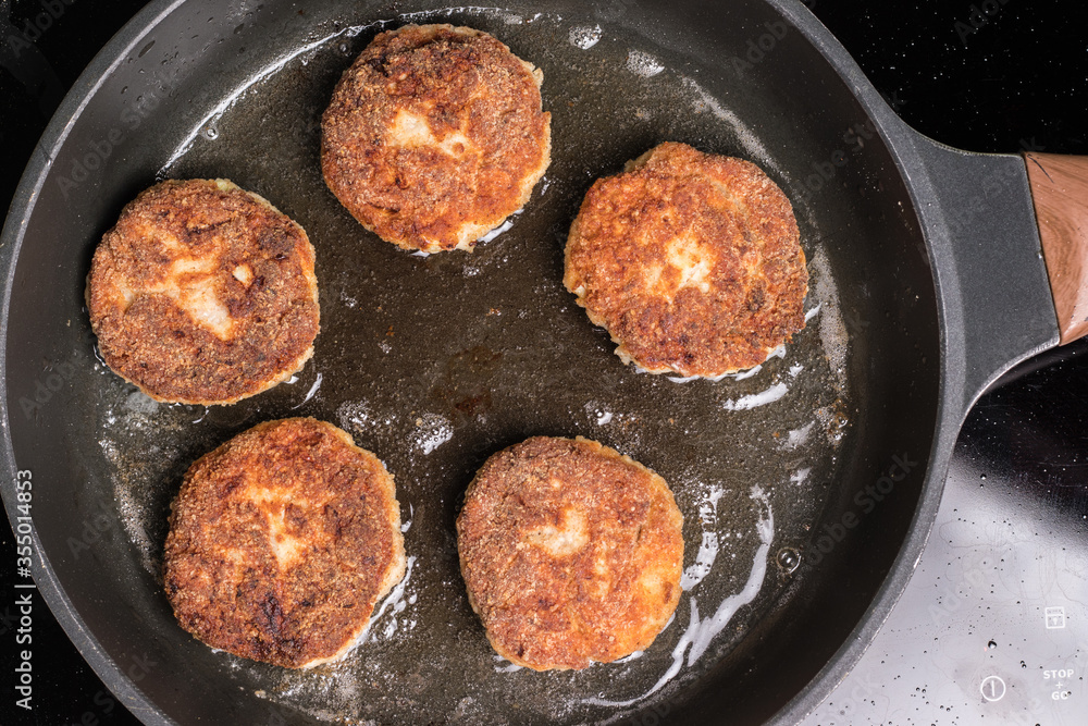 Roasted chicken cutlets in a pan. Frying process Roasted chicken cutlets in a pan. Frying process